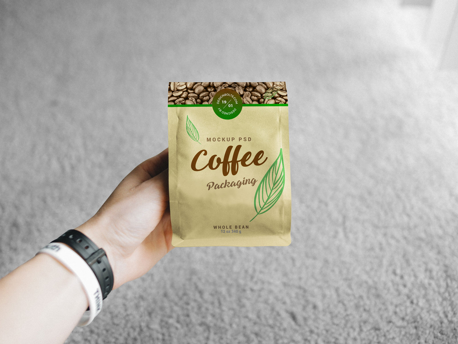 Free-Hand-Holding-Coffee-Packaging-Mockup-PSD