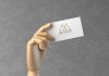 Free-Wooden-Hand-Holding-Business-Card-Mockup-PSD