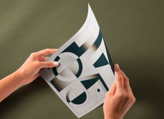 Free Hand Holding Glossy Paper Mockup PSD