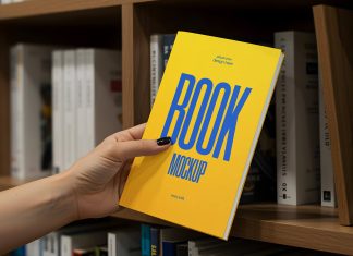 Free Hand Holding Thin Book Title Mockup PSD