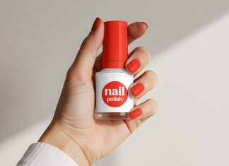Free Hand Holding Nail Polish Bottle Mockup PSD