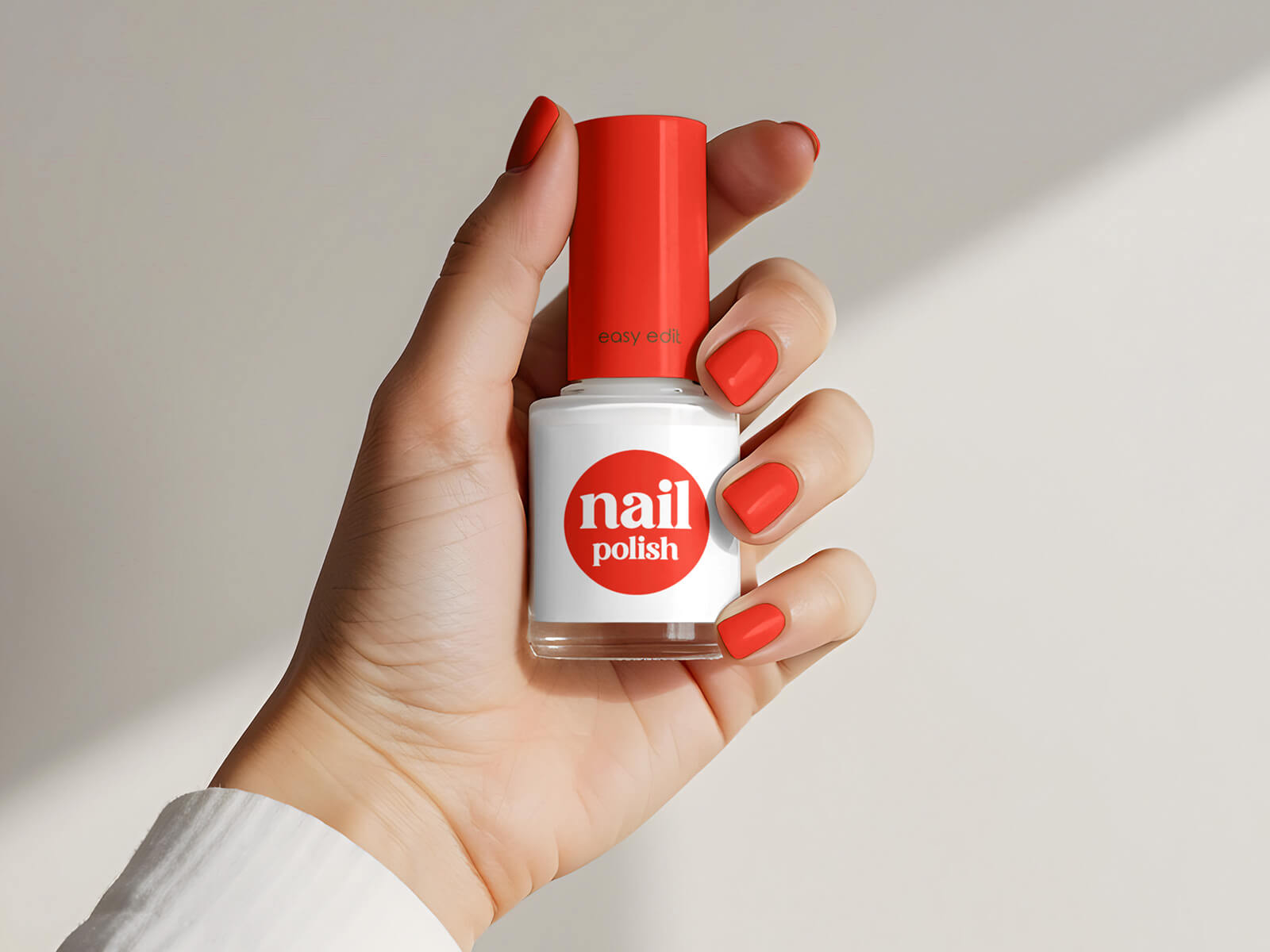 Free Hand Holding Nail Polish Bottle Mockup PSD
