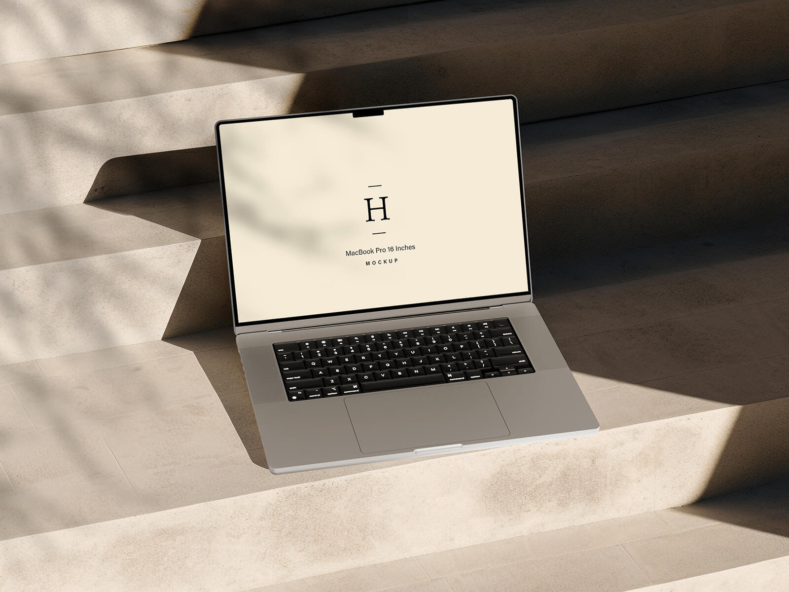 Free Shadow 16″ MacBook Pro Mockup PSD