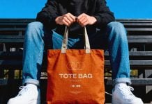 Free Hand-Holding Canvas Tote Bag Mockup PSD