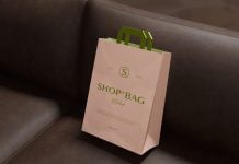 Free Paper Shopping Bag On Leather Sofa Mockup PSD