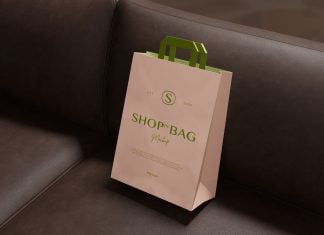 Free Paper Shopping Bag On Leather Sofa Mockup PSD